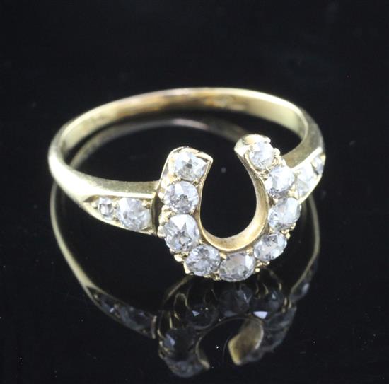 A late Victorian gold and diamond horseshoe ring, size P.